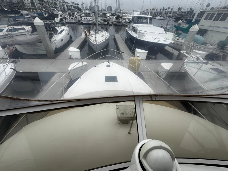 Slide: The Image of 1998 Sea Ray 370 Aft Cabin yacht docked at marina, surrounded by other boats. - 15