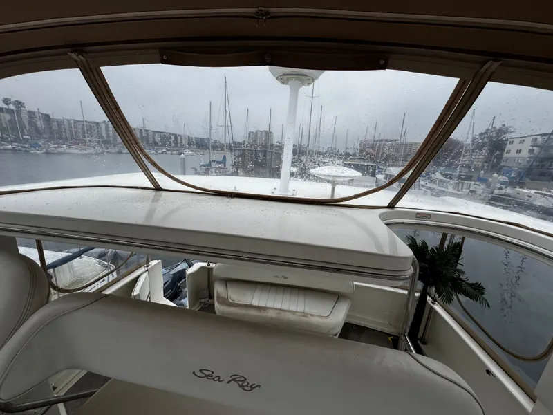 Slide: The Image of 1998 Sea Ray 370 Aft Cabin yacht interior with marina view through windows. - 16