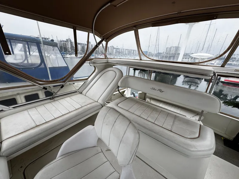 Slide: The Image of 1998 Sea Ray 370 Aft Cabin interior with white seating, docked at marina. - 19