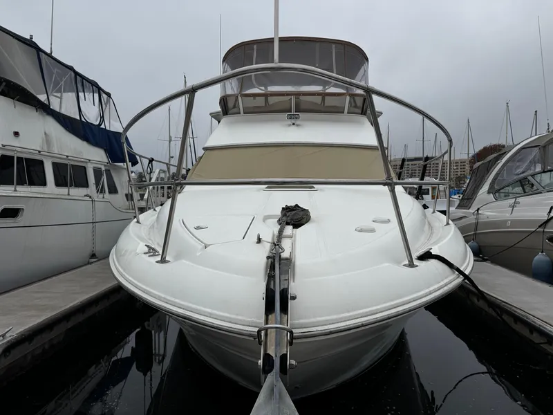 Slide: The Image of 1998 Sea Ray 370 Aft Cabin yacht docked at marina, front view. - 2