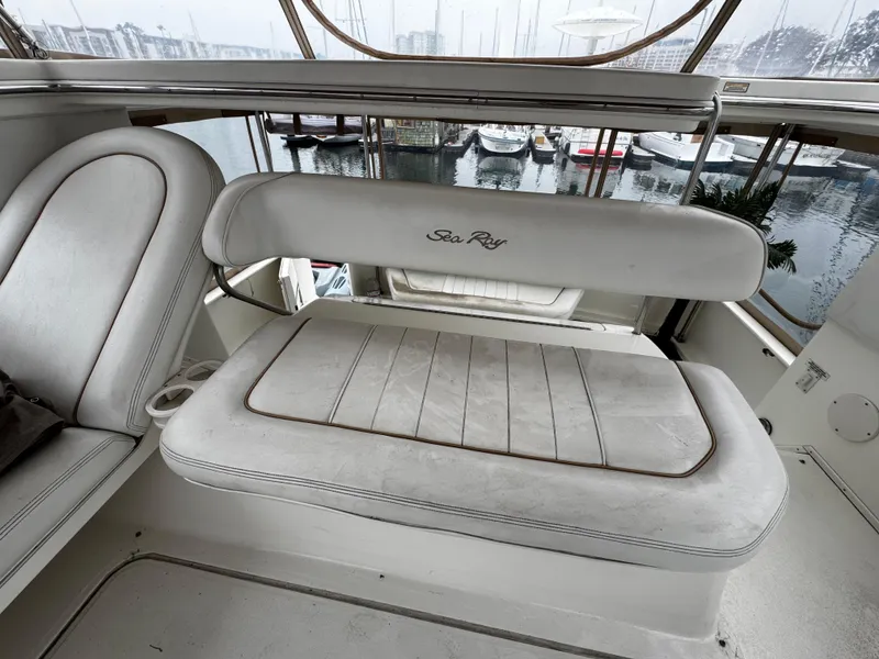Slide: The Image of 1998 Sea Ray 370 Aft Cabin interior seating with marina view. - 21