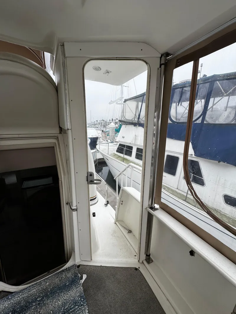 Slide: The Image of 1998 Sea Ray 370 Aft Cabin interior view with marina backdrop. - 27