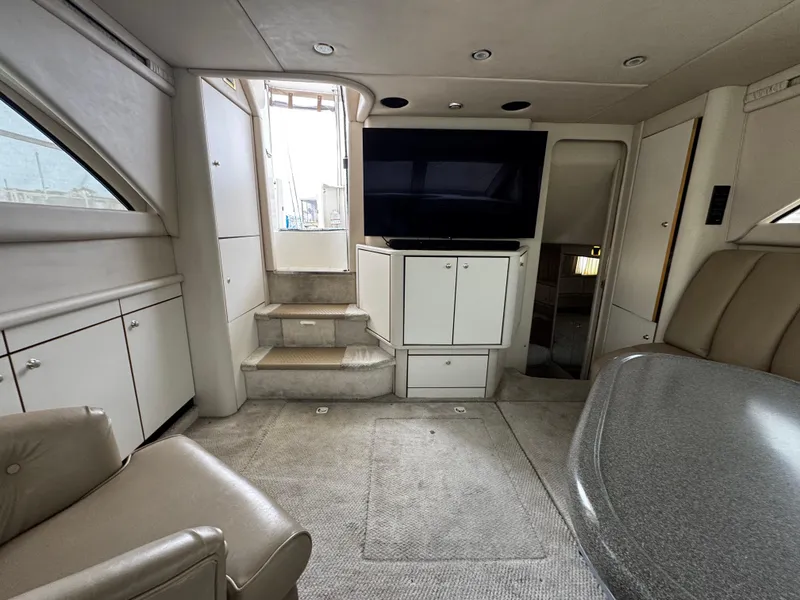 Slide: The Image of 1998 Sea Ray 370 Aft Cabin interior with modern furnishings and entertainment system. - 29