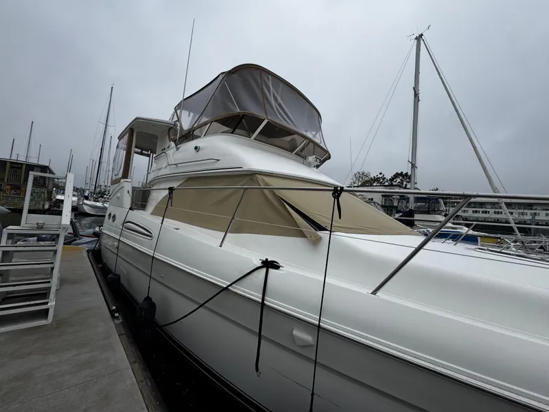 Slide: The Image of 1998 Sea Ray 370 Aft Cabin yacht docked at marina on a cloudy day. - 3
