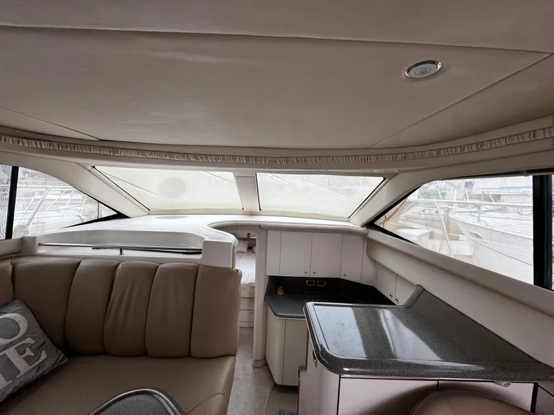 Slide: The Image of Interior of 1998 Sea Ray 370 Aft Cabin yacht with beige seating and kitchenette. - 37