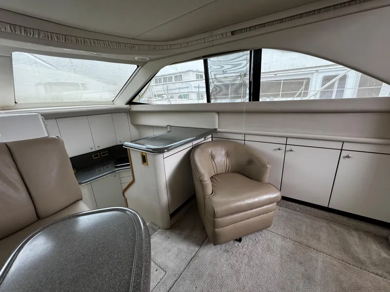 Slide: The Image of Interior of 1998 Sea Ray 370 Aft Cabin with beige seating and cabinetry. - 38