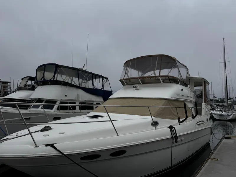 Slide: The Image of 1998 Sea Ray 370 Aft Cabin yacht docked at marina on a cloudy day. - 4