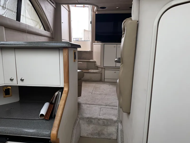 Slide: The Image of 1998 Sea Ray 370 Aft Cabin interior with modern furnishings and carpeted flooring. - 40