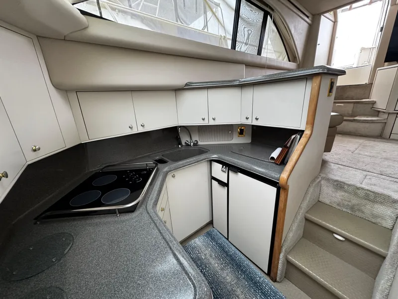 Slide: The Image of 1998 Sea Ray 370 Aft Cabin kitchen with modern appliances and sleek cabinetry. - 41