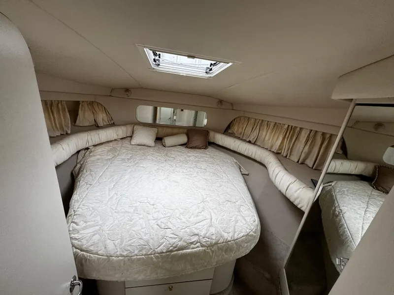 Slide: The Image of Cozy bedroom in 1998 Sea Ray 370 Aft Cabin yacht with skylight and plush bedding. - 49