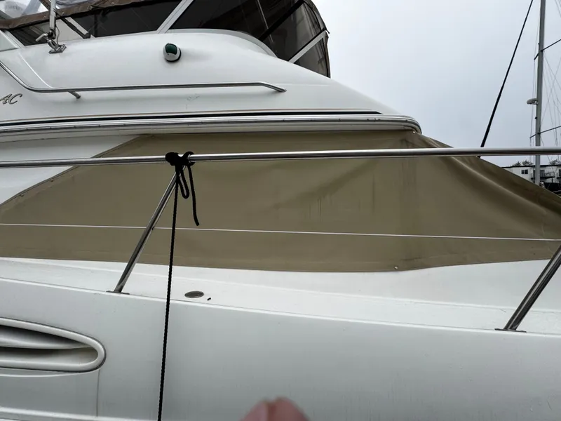 Slide: The Image of 1998 Sea Ray 370 Aft Cabin yacht with beige cover and sleek white exterior. - 6