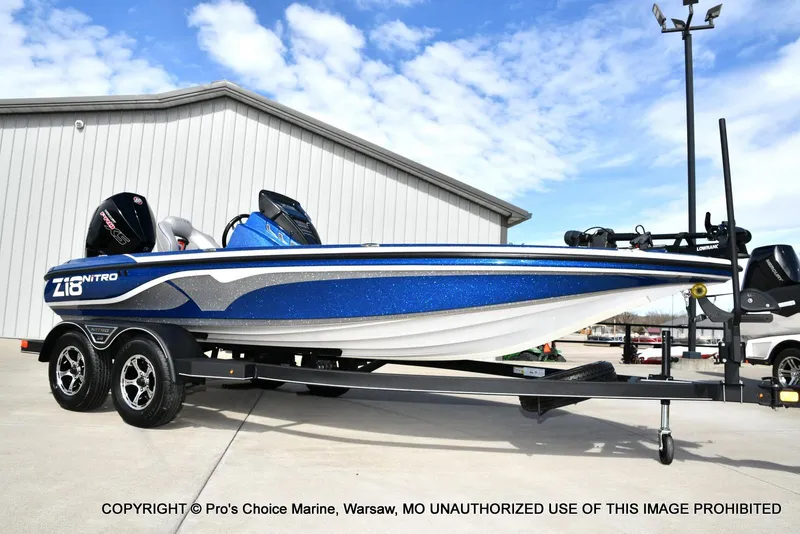 Slide: The Image of 2023 Nitro Z18 Pro boat with 175 Pro-XS engine on trailer, blue and white design. - 17