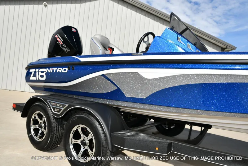 Slide: The Image of 2023 Nitro Z18 Pro boat with 175 Pro-XS engine, blue and silver design. - 18