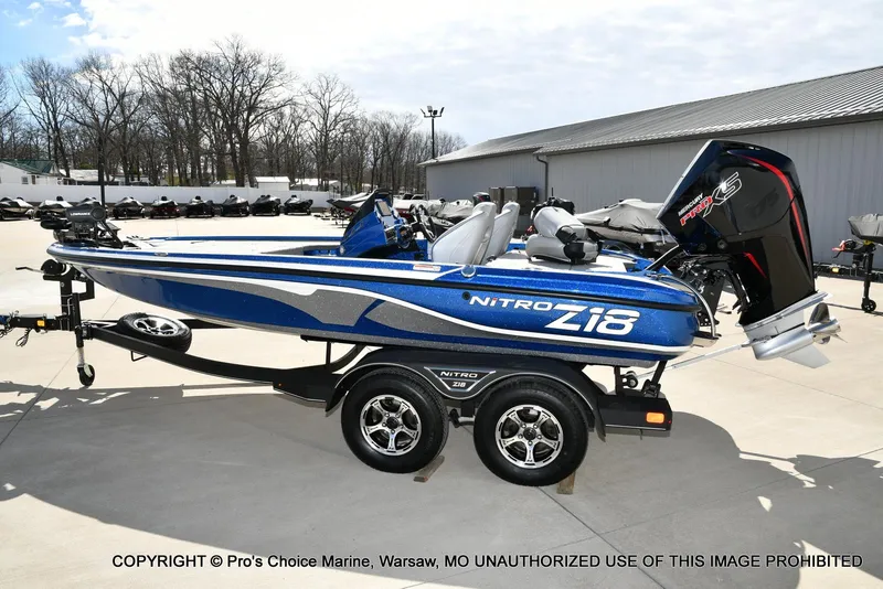 Slide: The Image of 2023 Nitro Z18 Pro boat with 175 Pro-XS engine on trailer, parked outdoors. - 29