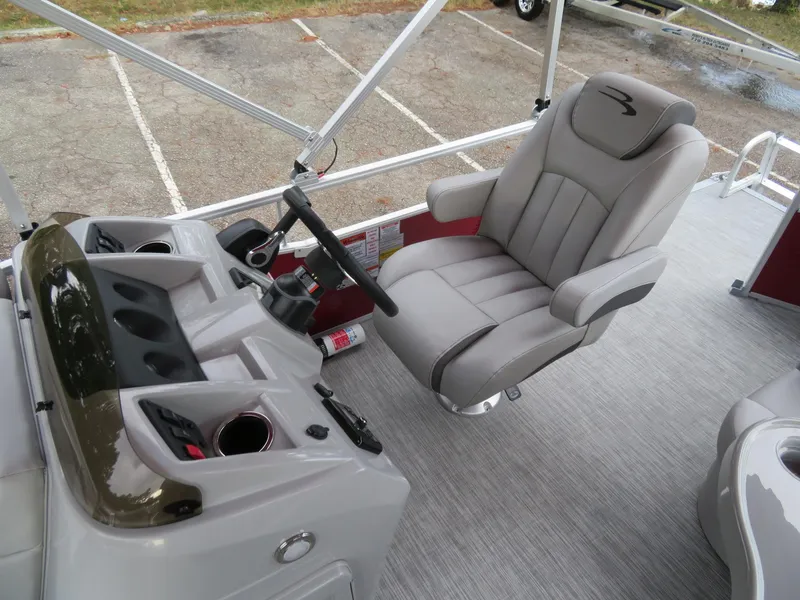 Slide: The Image of 2021 Bennington 20SLV boat interior with captain's chair and steering console. - 10