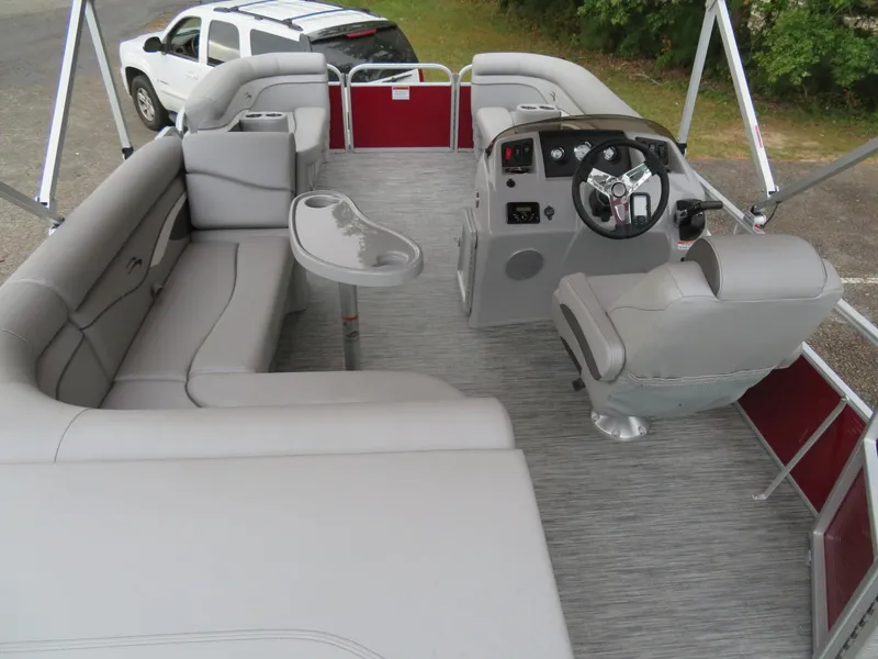 Slide: The Image of 2021 Bennington 20SLV pontoon boat interior with gray seating and steering console. - 11