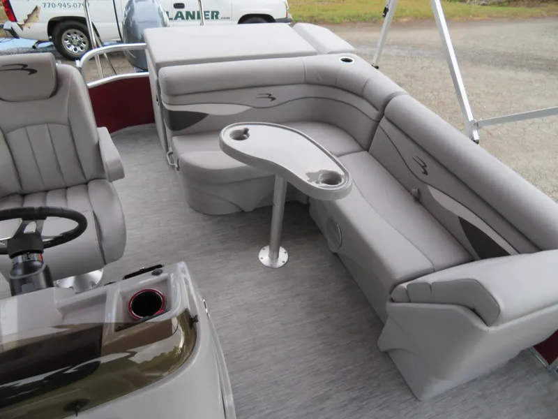 Slide: The Image of 2021 Bennington 20SLV pontoon boat interior with gray seating and table. - 12