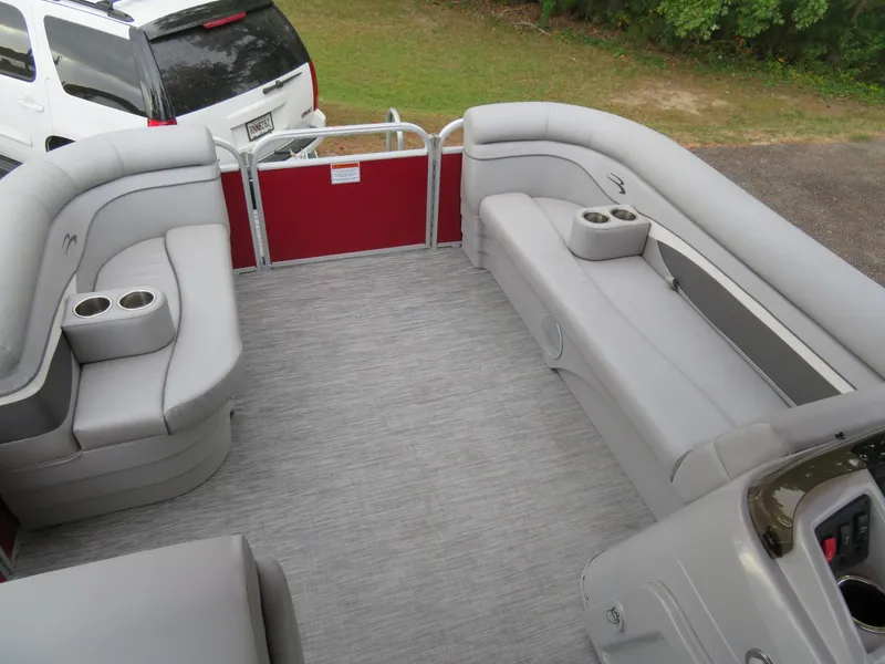 Slide: The Image of 2021 Bennington 20SLV pontoon boat interior with gray seating and cup holders. - 16