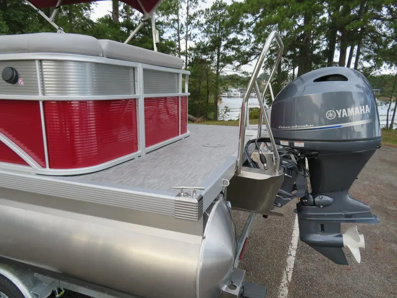Slide: The Image of 2021 Bennington 20SLV pontoon boat with Yamaha outboard motor, docked near a lake. - 5