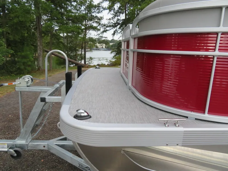 Slide: The Image of 2021 Bennington 20SLV pontoon boat on trailer near a scenic lake. - 6