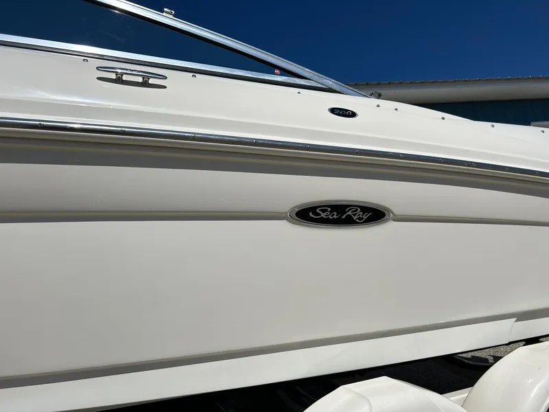 Slide: The Image of 2005 Sea Ray 200SP boat side view with logo and sleek white design. - 12