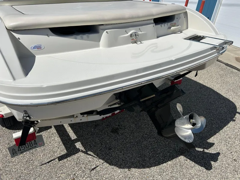 Slide: The Image of Rear view of a 2005 Sea Ray 200SP boat with visible propeller and trailer. - 13