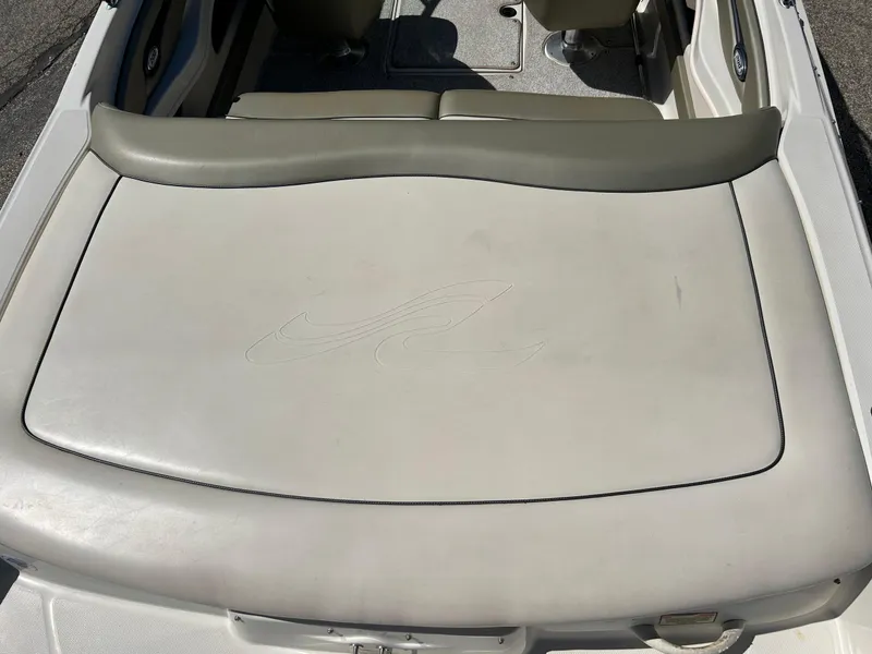 Slide: The Image of 2005 Sea Ray 200SP boat interior with cushioned seating and storage area. - 14