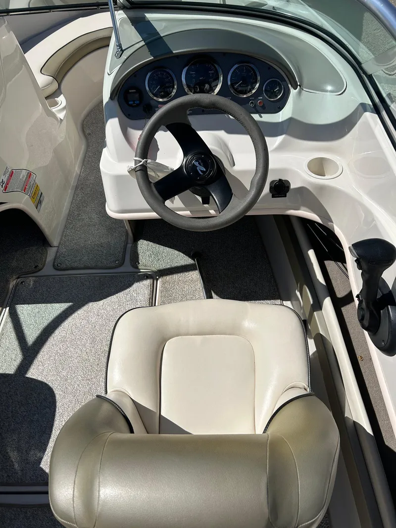 Slide: The Image of 2005 Sea Ray 200SP boat interior with steering wheel and dashboard. - 22