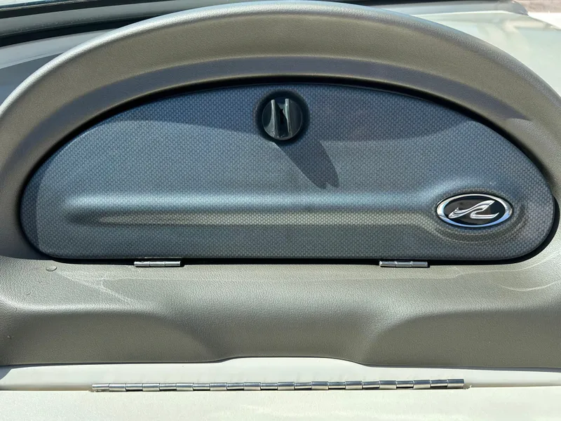 Slide: The Image of Dashboard of a 2005 Sea Ray 200SP boat with logo and storage compartment. - 25