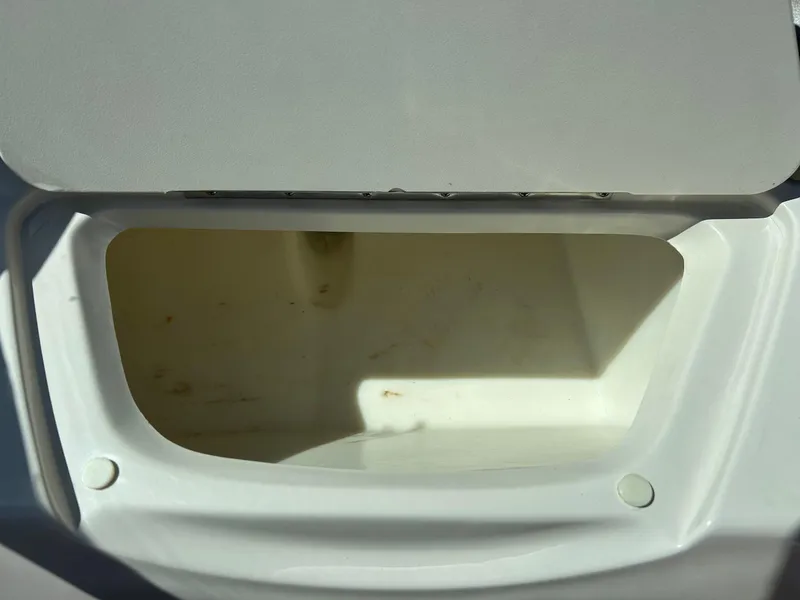 Slide: The Image of Open storage compartment on a 2005 Sea Ray 200SP boat. - 26