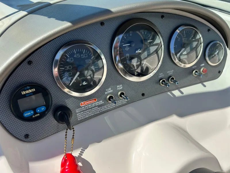 Slide: The Image of Dashboard of a 2005 Sea Ray 200SP boat with gauges and controls. - 28