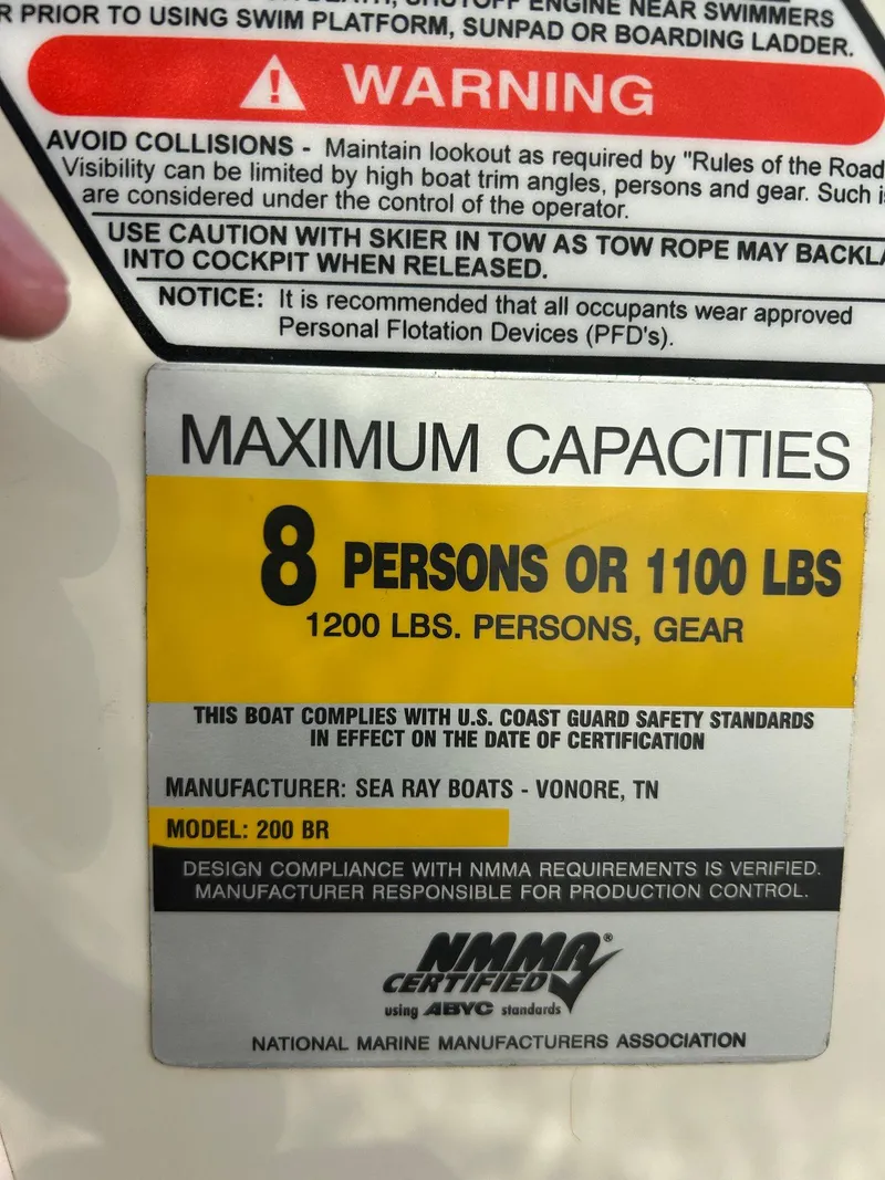 Slide: The Image of Sea Ray 200SP 2005 boat capacity label: 8 persons or 1100 lbs, 1200 lbs with gear. - 29