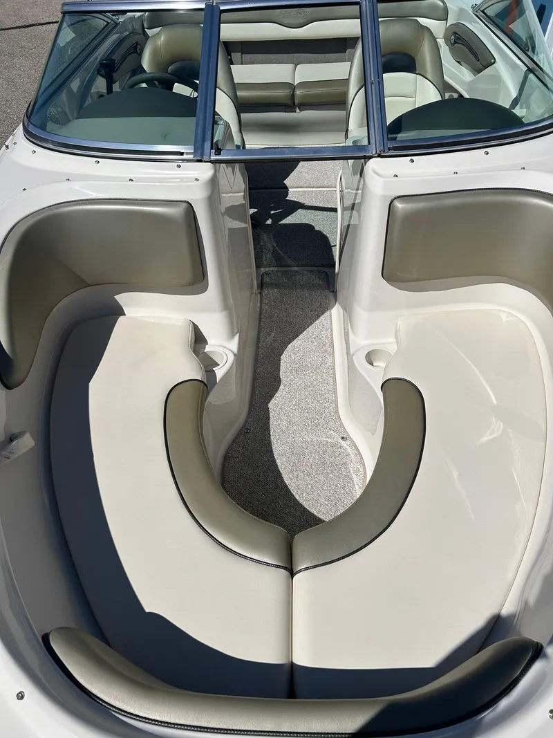 Slide: The Image of 2005 Sea Ray 200SP boat interior with beige seating and open bow design. - 3