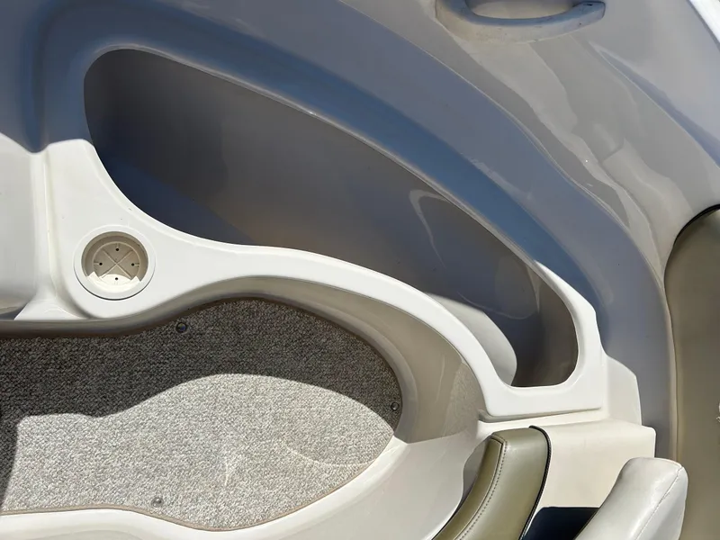 Slide: The Image of Interior view of a 2005 Sea Ray 200SP boat, featuring seating and storage compartments. - 31