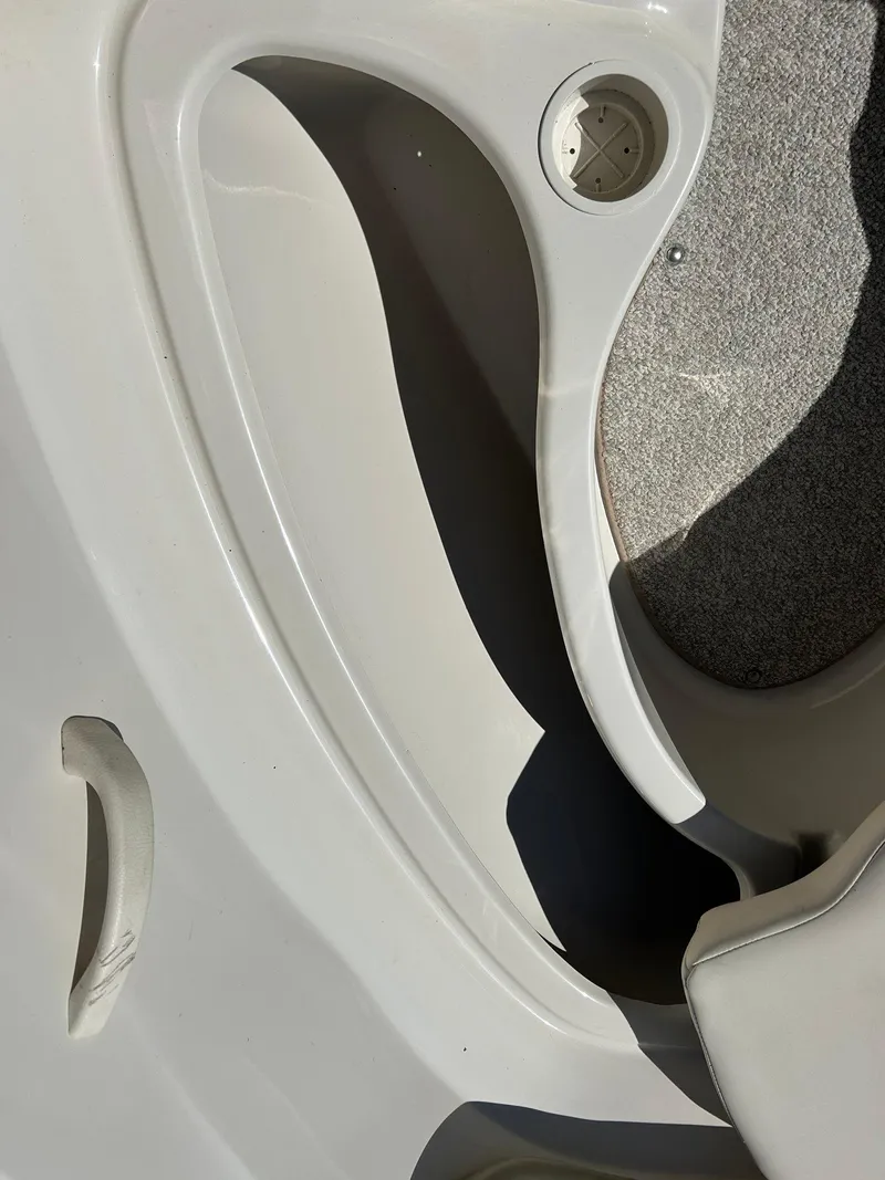 Slide: The Image of Interior detail of a 2005 Sea Ray 200SP boat, featuring seating and cup holder. - 32