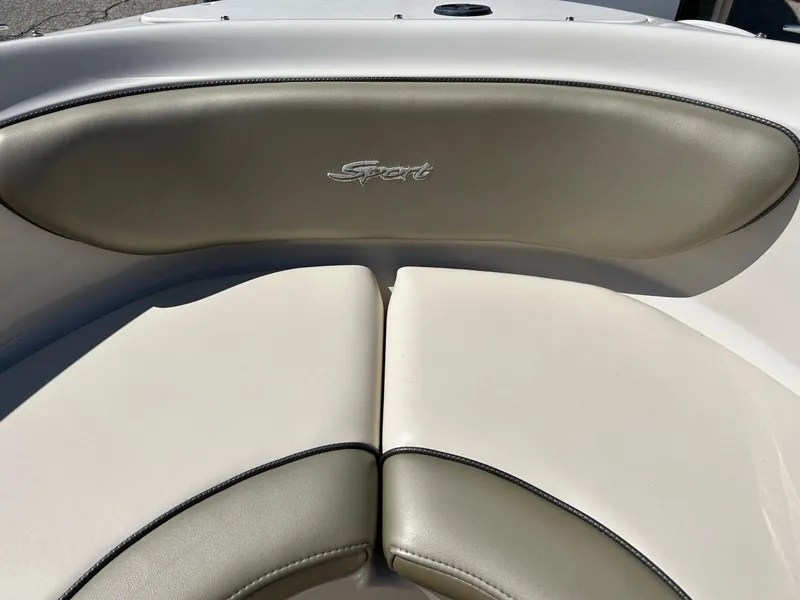 Slide: The Image of 2005 Sea Ray 200SP boat interior with beige cushioned seating and "Sport" logo. - 33
