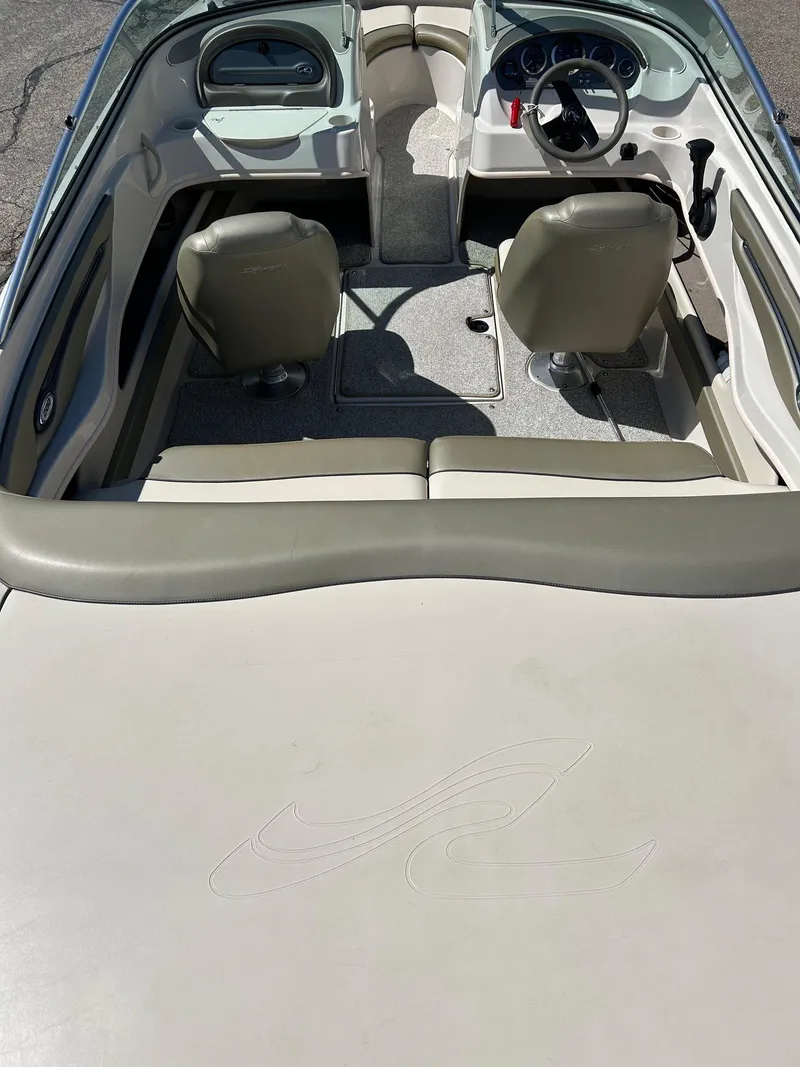 Slide: The Image of 2005 Sea Ray 200SP boat interior with beige seating and steering wheel. - 36