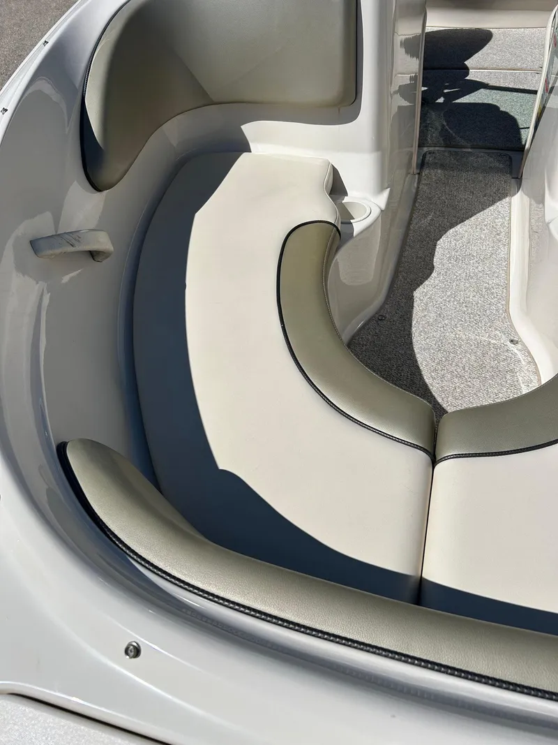 Slide: The Image of 2005 Sea Ray 200SP boat interior with curved seating and gray carpet. - 4