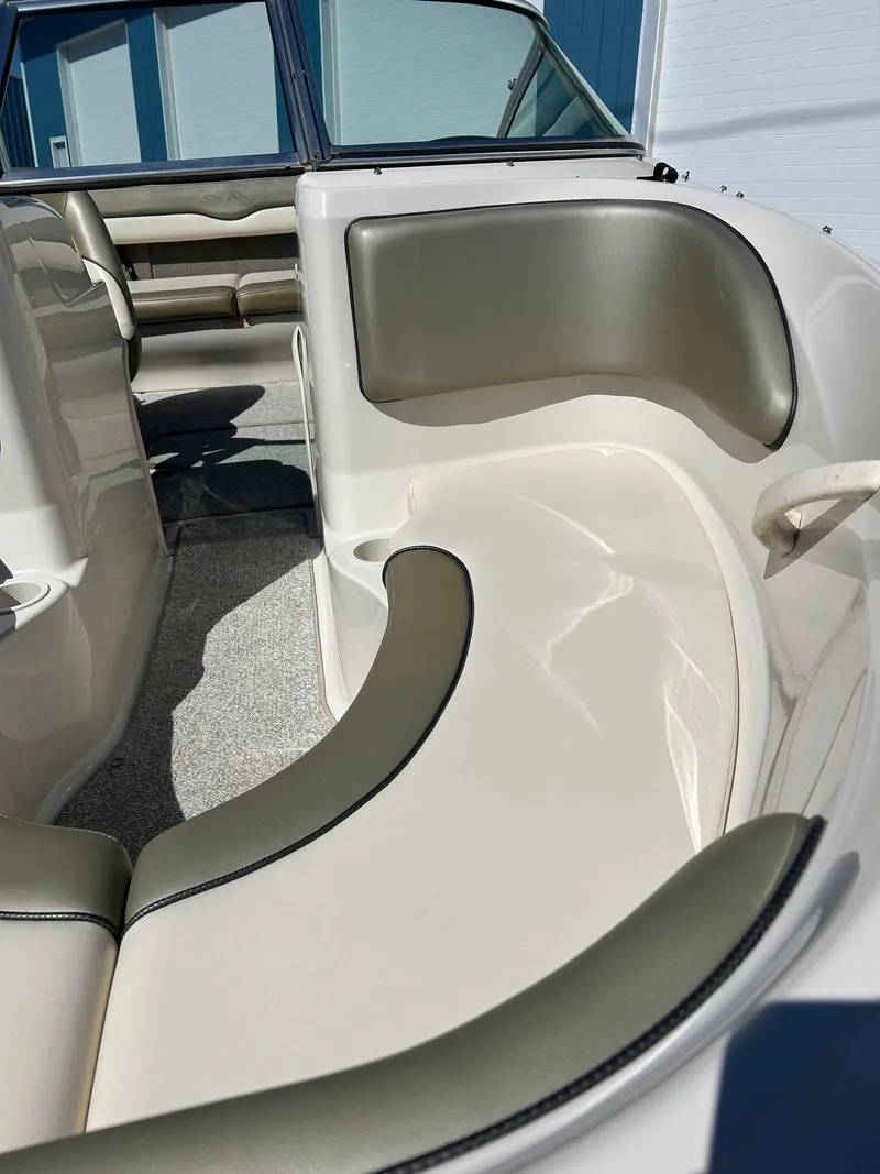 Slide: The Image of 2005 Sea Ray 200SP boat interior with beige seating and sleek design. - 5