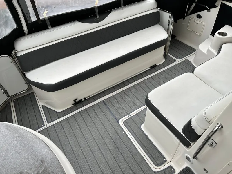 Slide: The Image of 2005 Regal 4260 Commodore boat interior with gray flooring and white seating. - 11