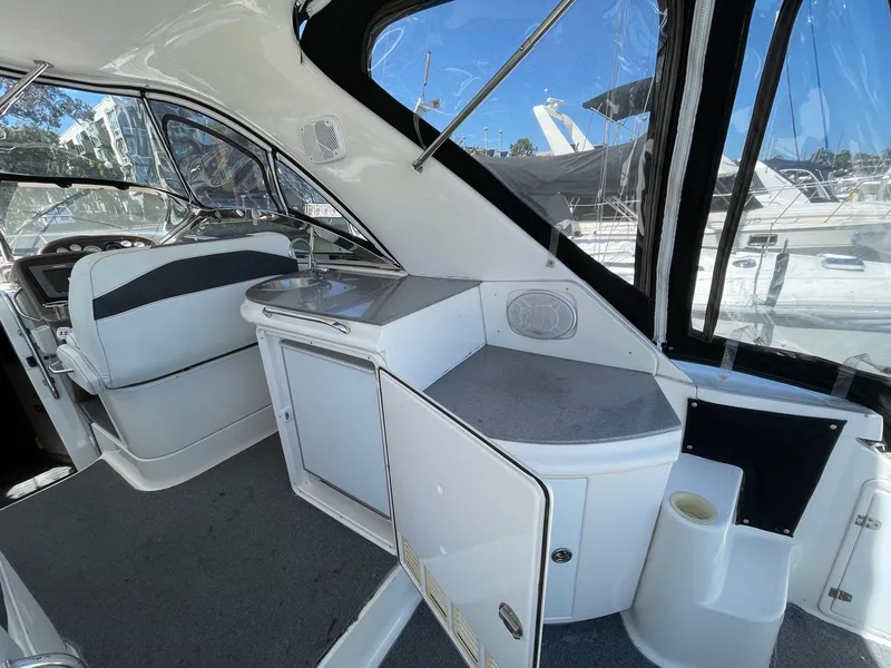 Slide: The Image of 2005 Regal 4260 COMMODORE yacht interior with sleek white cabinetry and seating. - 15