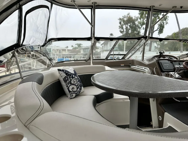 Slide: The Image of 2005 Regal 4260 Commodore yacht interior with curved seating and table. - 19