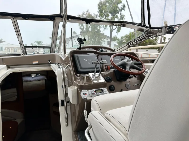 Slide: The Image of 2005 Regal 4260 COMMODORE helm with steering wheel, navigation system, and cabin entrance. - 22