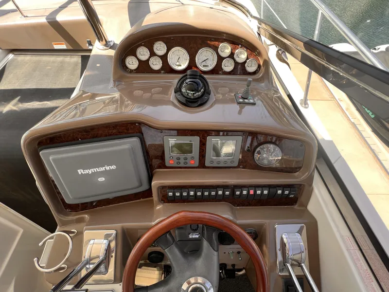 Slide: The Image of 2005 Regal 4260 COMMODORE helm with Raymarine navigation system and control panel. - 24