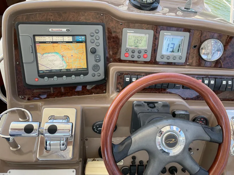 Slide: The Image of Control panel of a 2005 Regal 4260 COMMODORE yacht with navigation and steering features. - 26