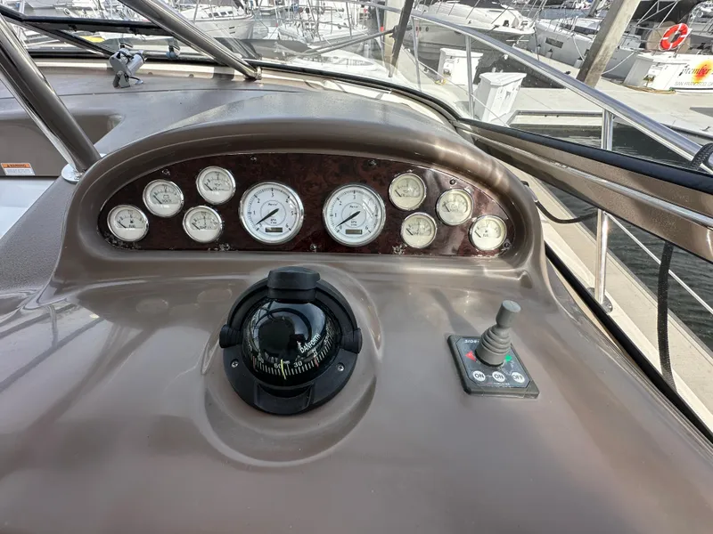 Slide: The Image of 2005 Regal 4260 COMMODORE dashboard with gauges and controls at marina. - 27