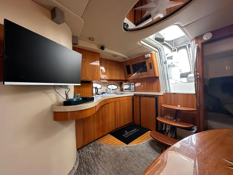 Slide: The Image of Interior of 2005 Regal 4260 Commodore yacht with modern kitchen and wooden cabinetry. - 38