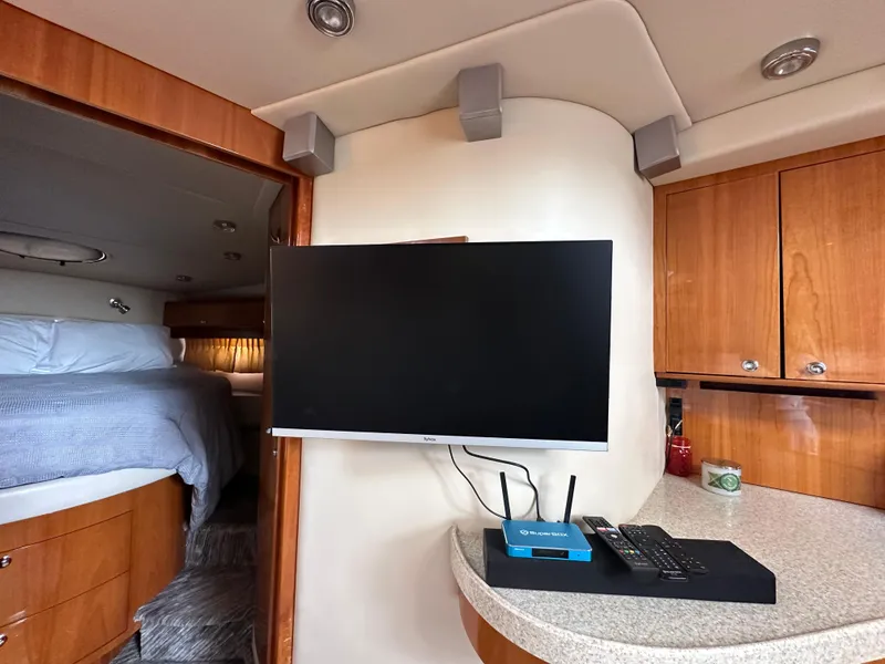 Slide: The Image of 2005 Regal 4260 COMMODORE yacht interior with TV, router, and cozy bedroom. - 40