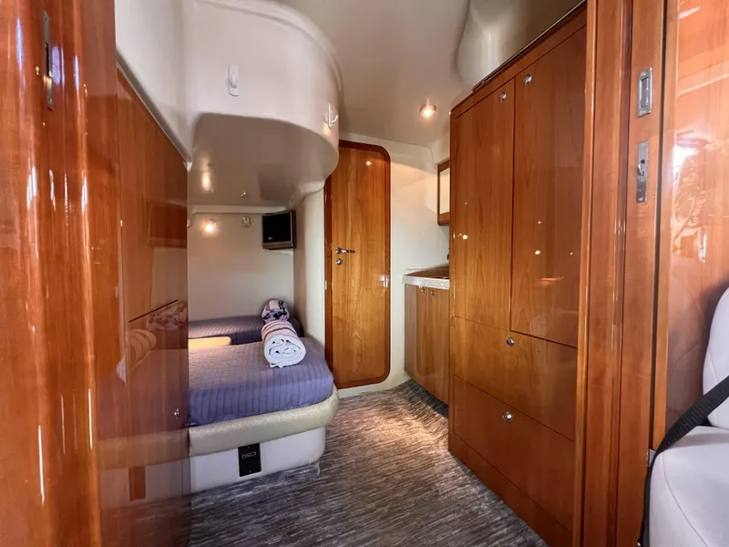 Slide: The Image of 2005 Regal 4260 COMMODORE yacht interior with wood finish and cozy sleeping area. - 46