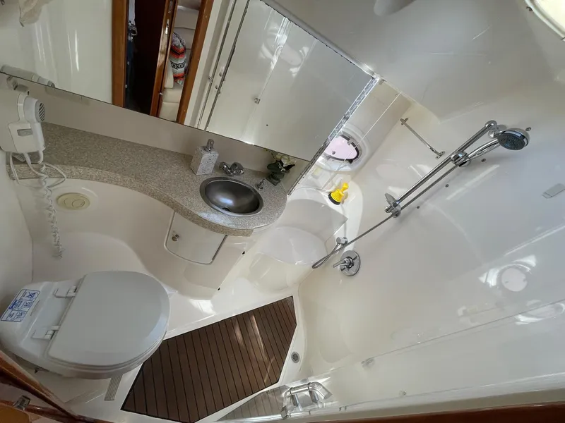 Slide: The Image of Luxurious bathroom in 2005 Regal 4260 Commodore yacht with modern fixtures and sleek design. - 49